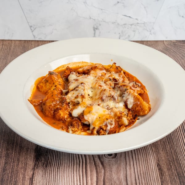 Don Eladio's Cantina's Mexican dish with chicken in red sauce, topped with melted cheese.