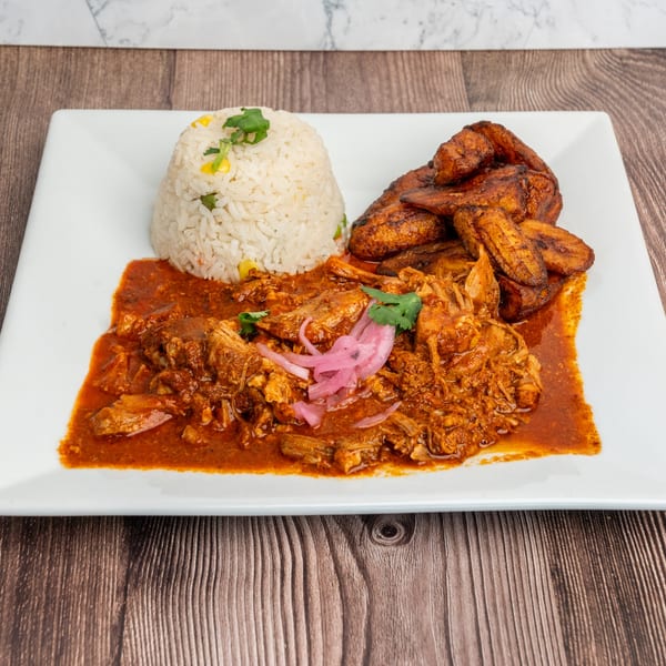 Don Eladio's Cantina's cochinita pibil with rice, fried plantains, and pickled red onions.
