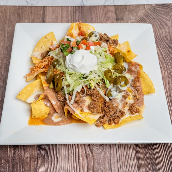Don Eladio's Cantina nachos with ground beef, shredded chicken, refried beans, jalapeños, and sour cream.