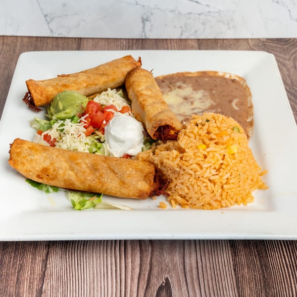 Don Eladio's Cantina taquitos with rice, refried beans, guacamole, sour cream, and salad.